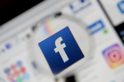 The Facebook logo is seen on a screen in this picture illustration taken