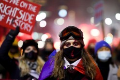 Demonstrators attend a protest against a decision restricting abortion rights in Warsaw,