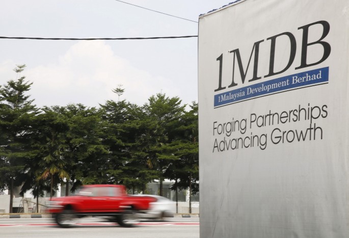 Traffic passes a 1Malaysia Development Berhad (1MDB) billboard at the Tun Razak Exchange development in Kuala Lumpur, Malaysia,