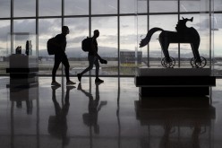 Passengers walk past artwork between terminals at IAH George Bush Intercontinental Airport amid the coronavirus disease (COVID-19) outbreak in Houston, Texas, U.S.
