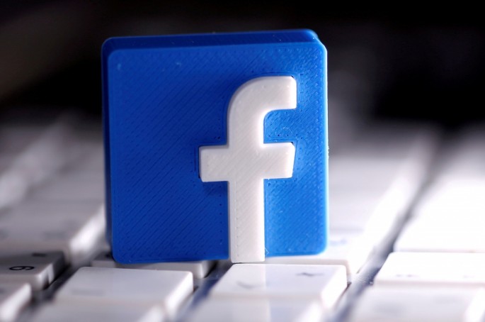 A 3D-printed Facebook logo is seen placed on a keyboard in this illustration taken