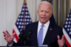 U.S. President Joe Biden responds to a question from a reporter after speaking about coronavirus disease (COVID-19) vaccines and booster shots in the State Dining Room at the White House in Washington, U.S.