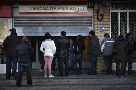 People wait to enter a government-run employment office in Madrid, Jan. 3, 2013.