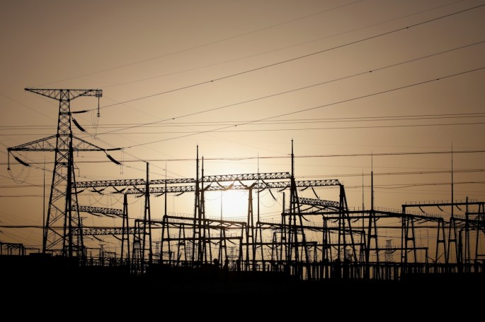 Electricity pylons and power lines are pictured at a power station near Yumen, Gansu province, China