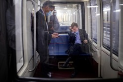 U.S. Senator Mark Warner (D-VA) rubs his eyes while riding the Senate Subway following a vote on Capitol Hill in Washington, U.S.