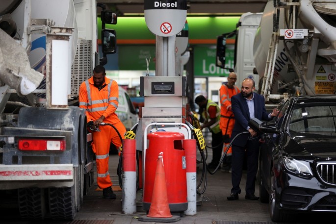 People refuel their vehicles at a fuel station in London, Britain,