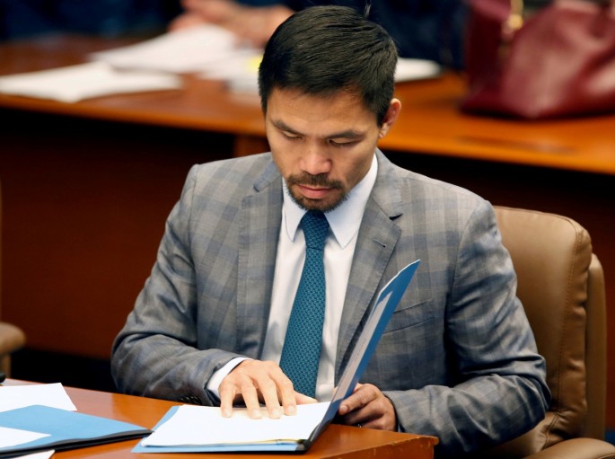 Philippine Senator and boxing champion Manny Pacquiao reads his briefing materials as he prepares for the Senate session in Pasay city, Metro Manila, Philippines September 20, 2016. Picture taken 