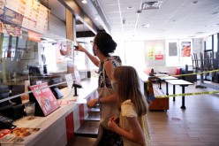 Naomi and Lydia Hassebroek order food from Taco Bell during the outbreak of the coronavirus disease (COVID-19) in Brooklyn, New York, U.S.