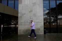 A man walks in front the Central bank headquarters building in Brasilia, Brazil