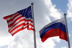 Russian and U.S. state flags fly near a factory in Vsevolozhsk, Leningrad Region, Russia