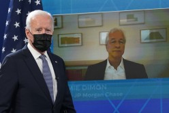 JP Morgan Chase CEO Jamie Dimon is seen on the video screen as U.S. President Joe Biden arrives for a hybrid virtual meeting with business leaders and CEOs about the debt limit at the White House in Washington, U.S.