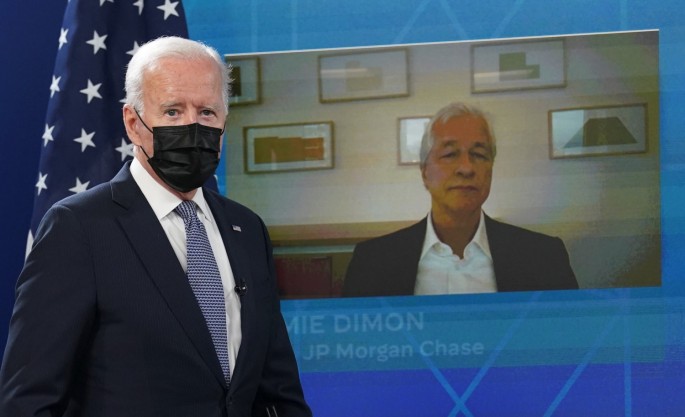 JP Morgan Chase CEO Jamie Dimon is seen on the video screen as U.S. President Joe Biden arrives for a hybrid virtual meeting with business leaders and CEOs about the debt limit at the White House in Washington, U.S.