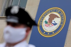 Security stands guard at the headquarters of the United States Department of Justice (DOJ) in Washington, D.C., U.S.