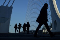 Commuters make their way into work in the morning in the financial district of Dublin, Ireland