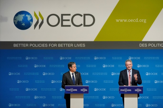 U.S. Secretary of State Antony Blinken listens as Mathias Cormann, Secretary-General of the Organization for Economic Cooperation and Development, speaks during a press briefing at the OECD's Ministerial Council Meeting, in Paris,