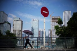 A man walks past a No Entry traffic sign near the headquarters of China Evergrande Group in Shenzhen, Guangdong province, China 