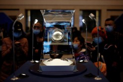 Visitors look at Moon samples from China's lunar exploration program Chang'e-5 Mission during an exhibition at the National Museum in Beijing, China