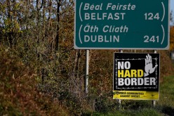 A 'No Hard Border' poster is seen below a road sign on the Irish side of the border between Ireland and Northern Ireland near Bridgend,