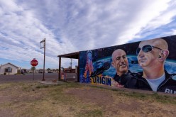 A mural of billionaire Jeff Bezos and his space company Blue Origin adorns the side of an empty building a day before his company will send 