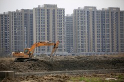 An excavator is seen at a construction site of new residential buildings in Shanghai, China