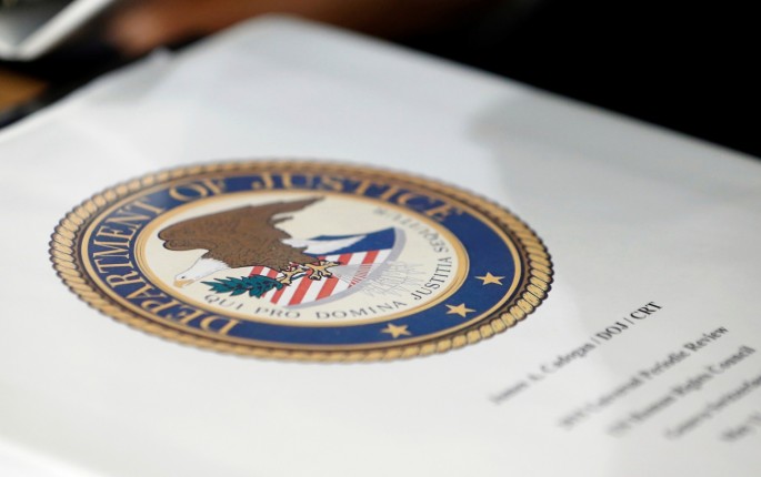 A folder with the seal of the U.S. Department of Justice sits on a table at the United Nations European headquarters in Geneva, Switzerland, 