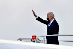 U.S. President Joe Biden waves as he boards Air Force One to depart O'Hare International Airport in Chicago, Illinois, U.S.,