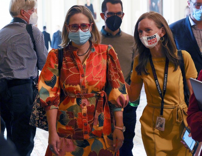 U.S. Senator Kyrsten Sinema (D-AZ) is pursued by reporters after it was announced that the U.S. Senate reached a deal to pass a $480 billion increase in Treasury Department borrowing authority, at the U.S. Capitol in Washington, U.S.,
