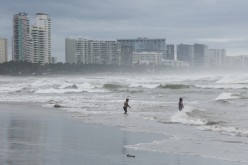 People are pictured on a beach as Hurricane Rick edges closer to Mexican coast north of Acapulco, Mexico