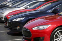 A row of Tesla Model S sedans are seen outside the company's headquarters in Palo Alto,
