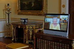 Britain's Queen Elizabeth appears on a screen via video link from Windsor Castle, where she is in residence, during a virtual audience to receive the Ambassador from the Republic of Korea, Gunn Kim, at Buckingham Palace, London, Britain