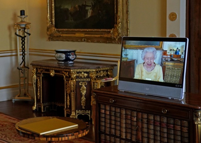 Britain's Queen Elizabeth appears on a screen via video link from Windsor Castle, where she is in residence, during a virtual audience to receive the Ambassador from the Republic of Korea, Gunn Kim, at Buckingham Palace, London, Britain