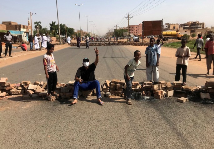 Protesters block a road during what the information ministry calls a military coup in Khartoum, Sudan,