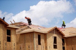 Carpenters work on building new townhomes that are still under construction while building material supplies are in high demand in Tampa, Florida, U.S.