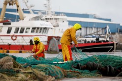 French fishermen repair their nets at Boulogne-sur-Mer, northern France, December 28, 2020. Picture taken