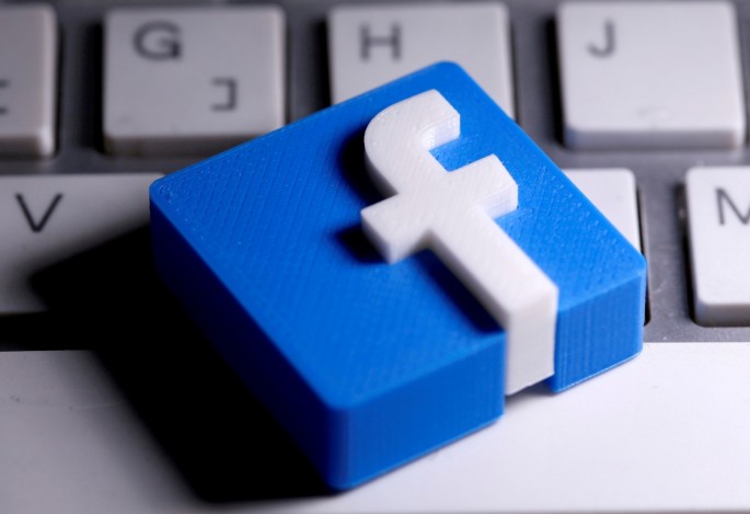 3D-printed Facebook logo is seen placed on a keyboard in this illustration taken