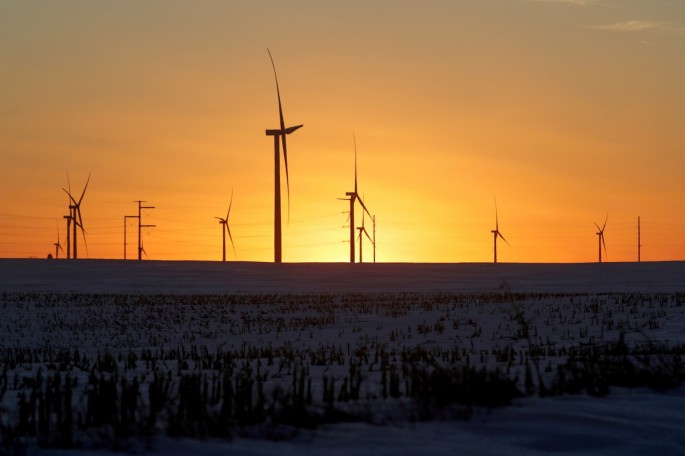 A wind farm shares space with corn fields the day before the Iowa caucuses, where agriculture and clean energy are key issues, in Latimer, Iowa, U.S