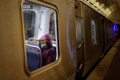 A passenger wears a protective face mask aboard a Washington Metro Rail Car in Washington, U.S.