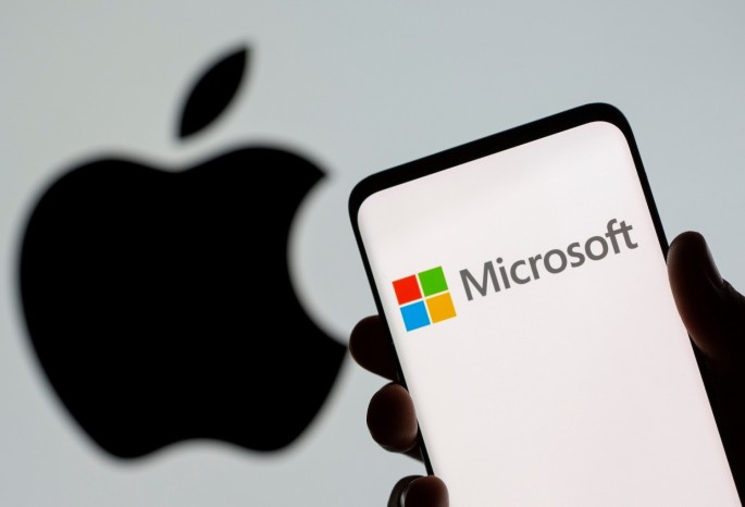 Microsoft logo is seen on the smartphone in front of displayed Apple logo in this illustration taken, 