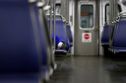 A person rests on a Washington Metro subway car wearing a face mask, following Mayor Muriel Bowser's declaration of a state of emergency due to the coronavirus disease (COVID-19) in Washington, U.S.