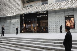 Men guard a Louis Vuitton store in Shanghai.