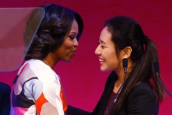 First Lady Michelle Obama (L) is greeted before a presentation on free speech at Peking University.