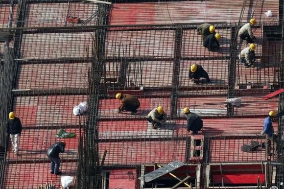Laborers work at a construction site in Shanghai, Jan. 16, 2014.