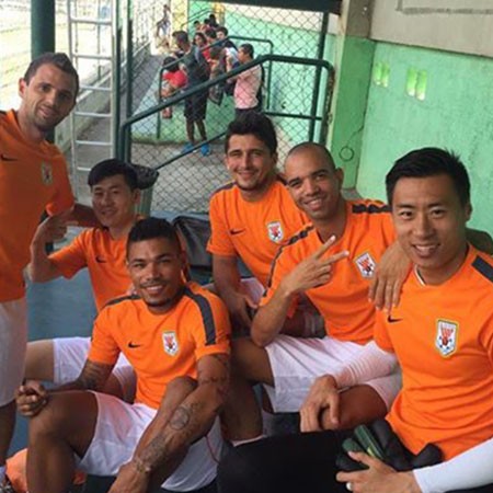 Diego Tardelli (second from right) with some members of the Shandong Luneng team after training.