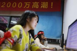 Employees of Tmall, part of Alibaba, work online to serve customers.