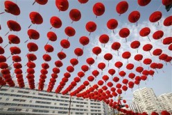 A worker prepares red lantern decorations for the Spring Festival Temple Fair at the entrance to Ditan Park in Beijing, Jan. 20, 2009.