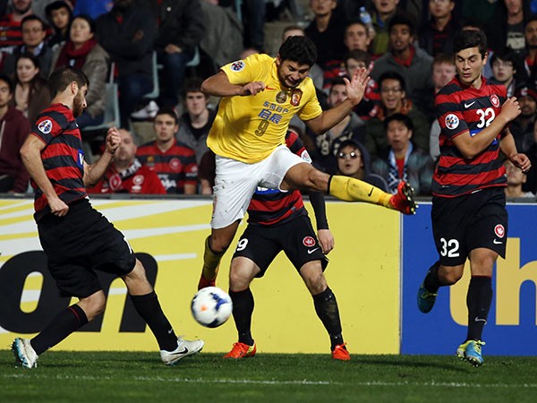 Guangzhou Evergrande's Elkeson fights for the ball as Western Sydney defenders try to tackle him.