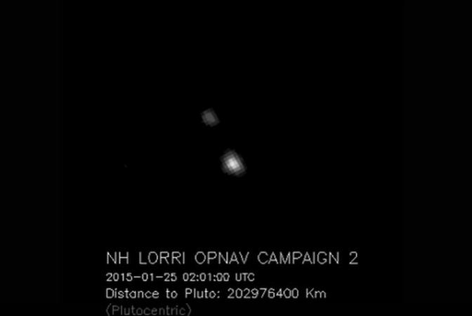 Pluto (bright blob) and Charon as seen from New Horizons