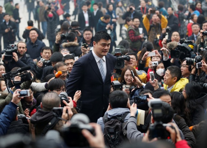 Yao Ming walks past the media on his way to the Great Hall of the People in Beijing.