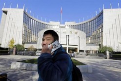 A man uses his mobile phone outside PBOC headquarters.