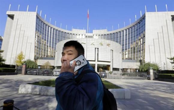 A man uses his mobile phone outside PBOC headquarters.